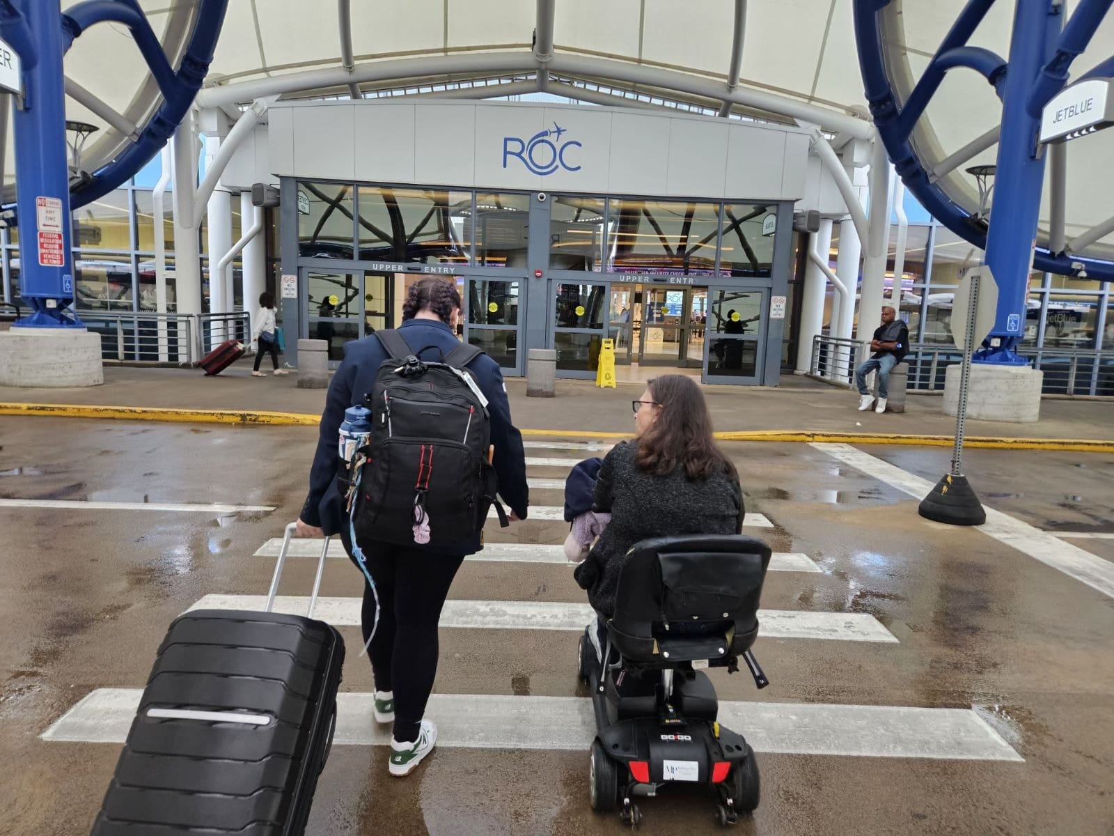 Maggie and her mom walking into the airport